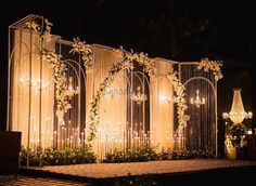 an outdoor wedding setup with flowers and chandeliers