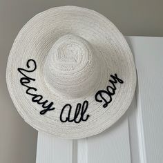 White Hat With Black Writing On The Back. Floppy, Classic Style Wide Brimmed Hat. New And Never Worn, But No Tags On It. White Flat Brim Boater Hat For Vacation, White Brimmed Boater Hat For Vacation, Casual Holiday Hat With Curved Brim, Casual White Boater Hat For Day Out, Casual Curved Brim Hats For Holiday, Casual Curved Brim Holiday Hat, Casual Curved Brim Hat For Holidays, White Boater Hat With Flat Brim For Day Out, White Flat Brim Boater Hat For Day Out