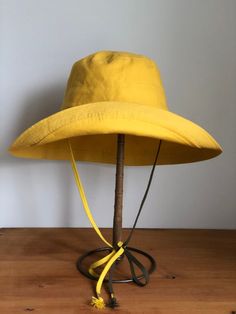 Izzy Bucket Hat Adjustable Wide Brim Cotton Hat, Adjustable Solid Color Bucket Hat With Flat Brim, Adjustable Fit Solid Sun Hat With Curved Brim, Solid Adjustable Fit Hat With Flat Brim, Adjustable Flat Brim Bucket Hat, Adjustable Cotton Fedora With Curved Brim, Yellow Curved Brim Hat For Outdoor, Adjustable Wide Brim Yellow Panama Hat, Adjustable Fit Wide Brim Hat