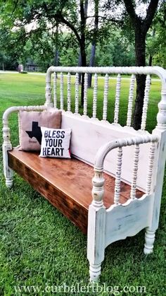 a bench made out of an old bed frame with a pillow sitting on top of it