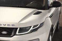 the front end of a white range rover parked in a parking lot