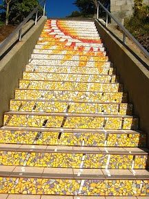 the stairs have been painted with yellow and white mosaic tiles, which are hand - painted