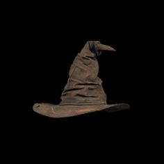 a hat that is sitting on top of a black surface in the dark night sky