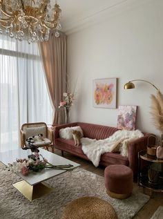 a living room filled with furniture and a chandelier