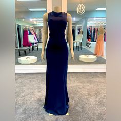 This Embellished Fitted Navy, And Gold Gown Is Embellished With Keyhole. Cut Outs In A Fully Beaded Gold Back. Perfect For An Elegant With A Touch Of Class Blue Prom Dress With Back Opening, Blue Evening Dress With Back Opening For Prom, Blue Floor-length Evening Dress With Back Opening, Blue Evening Dress With Back Opening For Gala, Blue Party Gown With Back Opening, Blue Gown With Back Opening For Party, Blue Dress With Back Opening And Fitted Bodice, Elegant Blue Gown With Back Opening, Elegant Blue Evening Dress With Back Opening