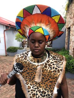 Step into the vibrant world of traditional Zulu heritage with this Extra Large Zulu Hat Set, a stunning ensemble that perfectly captures the essence of African culture and craftsmanship. This unique set includes a bold orange Zulu hat, a warrior-inspired isipango chestguard, a striking round gold choker necklace, and a beautifully beaded knobkerrie stick, making it the perfect attire for cultural celebrations, events, or decorative displays. The Extra Large Orange Zulu Hat is designed to command attention with its vivid hue and traditional Zulu silhouette, making it both an iconic piece and a statement of cultural pride. The Isipango Warrior Chestguard is crafted with intricate detailing, giving a nod to the valor and strength of Zulu warriors. Trimmed with premium materials, it provides a Zulu And Zephyr Hats, Zulu Hat, Zulu Bride, Basket Hat, African Crown, African Hat, Zulu Warrior, African Hats, Cultural Festival