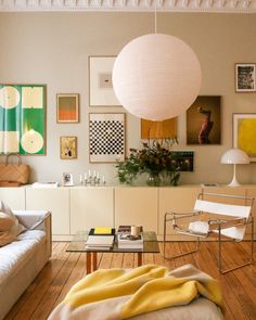 a living room filled with furniture and pictures on the wall