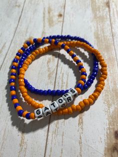 Team bracelets in a 3piece stack set to represent your team. Includes bracelet with name in orange and blue design, one orange and one blue. Bracelets are 7 1/2 inch. Bracelet With Name, Blue Bracelets, Team Bracelets, Letter Bead Bracelets, Stack Bracelets, Valentines Bracelets, Sports Bracelet, Tiger Eye Bracelet, Red Bracelets