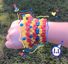 a person's arm with bracelets made out of plastic beads and hearts on it