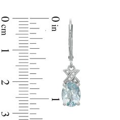 Update your look with a charming design when you wear these oval-shaped blue aquamarine and diamond accent "X" drop earrings. Fashioned in sterling silver Each drop shines with an 8.0 x 6.0mm oval-shaped icy-blue aquamarine. A diamond-accented "X"-shaped detail tops the dangle with shimmer. These earrings secure with lever backs. Peoples Jewellers, Sterling Silver Drop Earrings, Icy Blue, Aqua Marine, Aquamarine Blue, Silver Drop Earrings, Aquamarine, Sterling Silver Earrings, Elegant Design