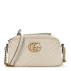 This is an authentic GUCCI Calfskin Matelasse Small GG Marmont Chain Shoulder Bag in White. This stylish shoulder bag is made of soft calfskin leather in off white. This shoulder bag features an aged gold chain and leather shoulder strap, and a Gucci GG logo on the front. The top zipper opens to a beige microfiber interior with a patch pocket. Gucci Soft Leather Crossbody Shoulder Bag, Gucci Luxury Soft Leather Shoulder Bag, Luxury Gucci Shoulder Bag In Soft Leather, Luxury Gucci Soft Leather Shoulder Bag, White Leather Gucci Shoulder Bag, Elegant Gucci Soft Leather Bags, White Gucci Shoulder Bag With Chain Strap, Gucci Cream Leather Shoulder Bag, White Gucci Shoulder Bag For Evening