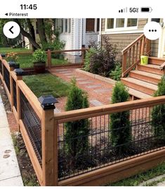 an image of a fenced in yard with plants on the side and steps leading up to it