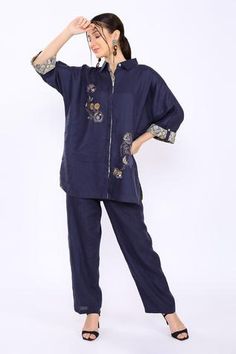 Navy shirt with floral embroidery and cuff sleeves.
Components:1
Pattern:Embroidered
Type of Work:Floral
Neckline:Shirt Collar
Sleeve Type:Cuff
Fabric:100% Pure Linen
Color:Blue
Other Details:
Note: Pant worn by the model is not for sale
Occasion:Work - Aza Fashions Blue Cotton Top With Embroidered Sleeves, Cotton Embroidered Cuff Long Sleeve Top, Linen Pants Outfit Fall, Blue Linen Pants Outfit, Navy Blue Linen Pants, Long Sleeve Embroidered Blue Tunic, Spring Blue T-shirt With Floral Embroidery, Blue Floral Embroidered Tunic Kurta, Blue Linen Pants