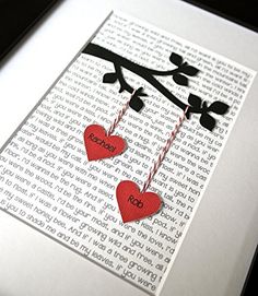 two paper hearts hanging from a tree branch