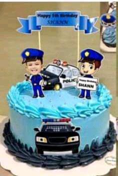 a birthday cake with two police officers on top