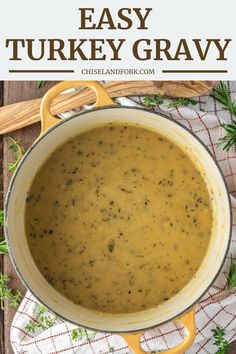 a pot full of easy turkey gravy sitting on top of a wooden table