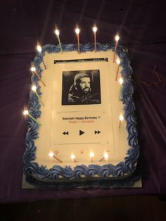 a sheet cake with candles and a photo on it