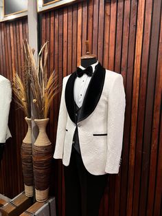 a tuxedo suit and bow tie are on display in a room with wood paneling