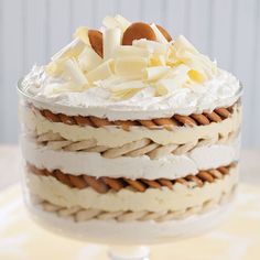 a layered cake with white frosting and toppings