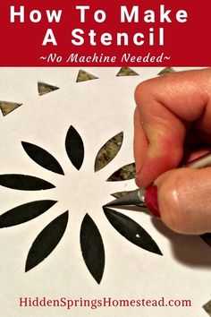 someone using scissors to make a stencil on paper with the words how to make a stencil no machine needed