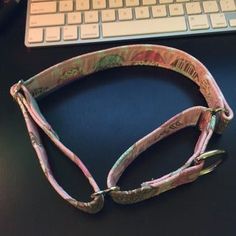 a neck tie sitting next to a keyboard on a desk with a mouse in the background