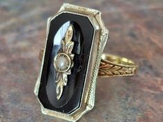 an antique black and white stone ring on a table