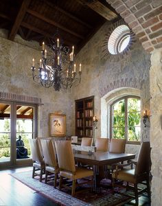 a dining room with stone walls and windows