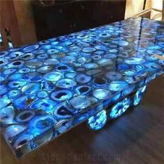 a table that has been made out of glass with blue and white circles on it