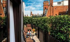 a balcony with chairs and tables on it