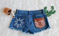 Bohemian Denim Cutoff Jean Shorts, Bohemian Cutoff Denim Jean Shorts, Bohemian Denim Jean Shorts For Summer, Bohemian Denim Jean Shorts, Bohemian Denim Shorts For Festivals, Bohemian Cutoff Bottoms With Frayed Hem, Summer Bohemian Cotton Jean Shorts, Bohemian Cotton Jean Shorts For Summer, Western Denim Bottoms For Summer