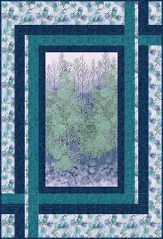 a blue and white quilt with trees in the background