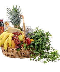 a wicker basket filled with fruit and vegetables