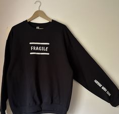 This mental health crew neck will be your go to top! Wear it as a layering piece or solo with a pair of jeans. It is the perfect piece to raise awareness in a cute and comfy way! 'Fragile' shows on the front of the sweat shirt, and 'handle with care' is located on the sleeve. - 50% cotton, 50% polyester - Wash inside out to preserve design - Cold wash settings only - For ages 13 and up FREE SHIPPING - Your order will be sent with a tracking number - Shipping and delivery in United States ONLY - Stretch Letter Print Crew Neck Sweatshirt, Trendy Stretch Sweatshirt For Everyday, Stretch Crew Neck Sweatshirt With Letter Print, Stretch Trendy Sweatshirt For Everyday, Everyday Stretch Black Sweatshirt, Everyday Black Stretch Sweatshirt, Unisex Black Crew Neck Sweatshirt, Washed Black Crew Neck T-shirt With Band Merch, Moisture-wicking Crew Neck Sweatshirt For Streetwear