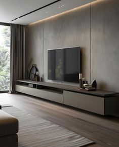 a living room with a large tv on the wall