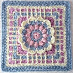 a crocheted square with a flower on it