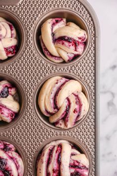 muffins with blueberry swirl in a muffin tin