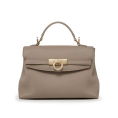 Inspired by Grace Kelly's enduring style, the Grace Soft Top Handle Bag is meticulously crafted from premium USA full-grain textured calfskin leather, ensuring both durability and elegance. Its timeless and versatile design features a thoughtfully structured interior that comfortably accommodates all your everyday essentials. Whether day or night, you'll find yourself instinctively reaching for this chic and easy-to-wear masterpiece. Elegant Beige Pebbled Leather Shoulder Bag, Elegant Pebbled Leather Shoulder Bag With Soft Leather, Elegant Shoulder Bag In Pebbled Leather, Beige Pebbled Leather Top-handle Satchel, Beige Pebbled Leather Top Handle Satchel, Elegant Soft Pebbled Leather Shoulder Bag, Elegant Brown Pebbled Leather Bags, Luxury Taupe Textured Leather Bag, Classic Taupe Bags With Gold-tone Hardware