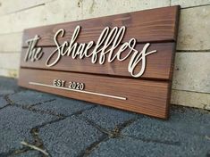 a wooden sign that says the schnefflers on it's side