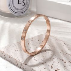 Sku: NSB1550STZD Details: This 14K gold/rose gold PVD bangle embellished with clear five of our best CZ stones arranged in an attractive and pleasing pattern, this will catch the light from any angle. Whether you want the brilliant shine of stone or the steady shimmer of metal, this bracelet gives you everything.Its sleek and modern silhouette combines well with other bangles or bracelets to create an on-trend stacked look. Stainless Steel 316L features: With its resistance to rust and oxidation Gold Bangle Bracelet, Silver Bangle Bracelets, Cz Stone, Gold Rose, Bangle Bracelet, Bangle Bracelets, Jewelry Design, Bangles, Wedding Rings