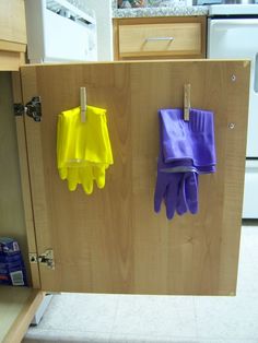 two oven mitts are hanging on the wall next to each other in front of an oven