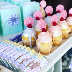 cupcakes are lined up on a table