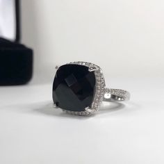 Gorgeous Black Onyx & Sterling Ring * Genuine Cushion Cut Black Onyx measures 12x12mm * Brilliant Cut Cubic Zirconia accents * Solid Sterling Silver * Size 6, 7 or 8 - Select Your Size Hallmarked & Gift Ready! TIMELESS, BEAUTIFUL & UNIQUE FINE ART JEWELRY! Elegant Black Rings For Formal Occasions, Classic Black Jewelry With Accent Stones, Formal Black Rings With Accent Stones, Luxury Black Rings With Vs Clarity, Black Formal Jewelry With Accent Stones, Elegant Black Ring With Center Stone, Elegant Black Jewelry With Accent Stones, Black Rings With Halo Setting For Gift, Black Jewelry With Center Stone As A Gift