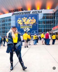 a woman standing in front of a large building