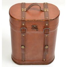 a large brown leather suitcase sitting on top of a white floor