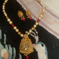 Beautiful Bollywood Style Kundan Gold Plated Pendent Necklace Earring Set. Lovely Dark Crimson Red Color Pearl , Golden Pearl And Creamy White . The Earring Are Gold Plated With Stone In The Middle Hanging White Color And Dark Crimson Red Beat 'S For More See The Pic . Red Elegant Jewelry With Pearl Pendant, Elegant Red Jewelry With Pearl Pendant, Traditional Pearl Pendant Jewelry Sets As Gift, Temple Jewelry Sets With Pendant As Gifts, Temple Jewelry Pendant Sets As Gifts, Red Pearl Pendant Jewelry For Gift, Red Pearl Pendant Jewelry Gift, Festive Red Necklace With Matching Earrings, Red Necklaces With Matching Earrings For Festivals