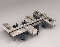 an office cubicle with two desks and chairs