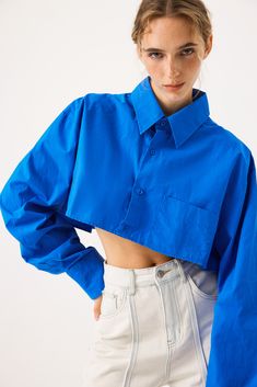 Simple yet stylish, this button-down shirt stands out with a cropped, boxy cut. The plain white and rich blue shade present different styles. Luxury Collared Cropped Shirt For Spring, Cheap Fitted Collared Crop Top, Cheap Trendy Buttoned Crop Top, Cheap Chic Collared Cropped Shirt, Luxury Cropped Shirt For Workwear, Cheap Blue Tops With Button Cuffs, Luxury Cropped Shirt For Work, Luxury Chic Collared Cropped Shirt, Cheap Chic Cropped Short Sleeve Shirt