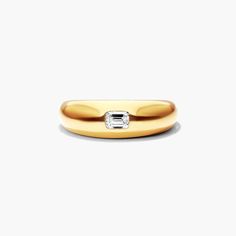 a gold ring with a diamond on the top and bottom, against a white background