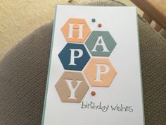 a birthday card with the words happy on it and hexagons in different colors