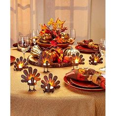 a table topped with lots of thanksgiving decorations